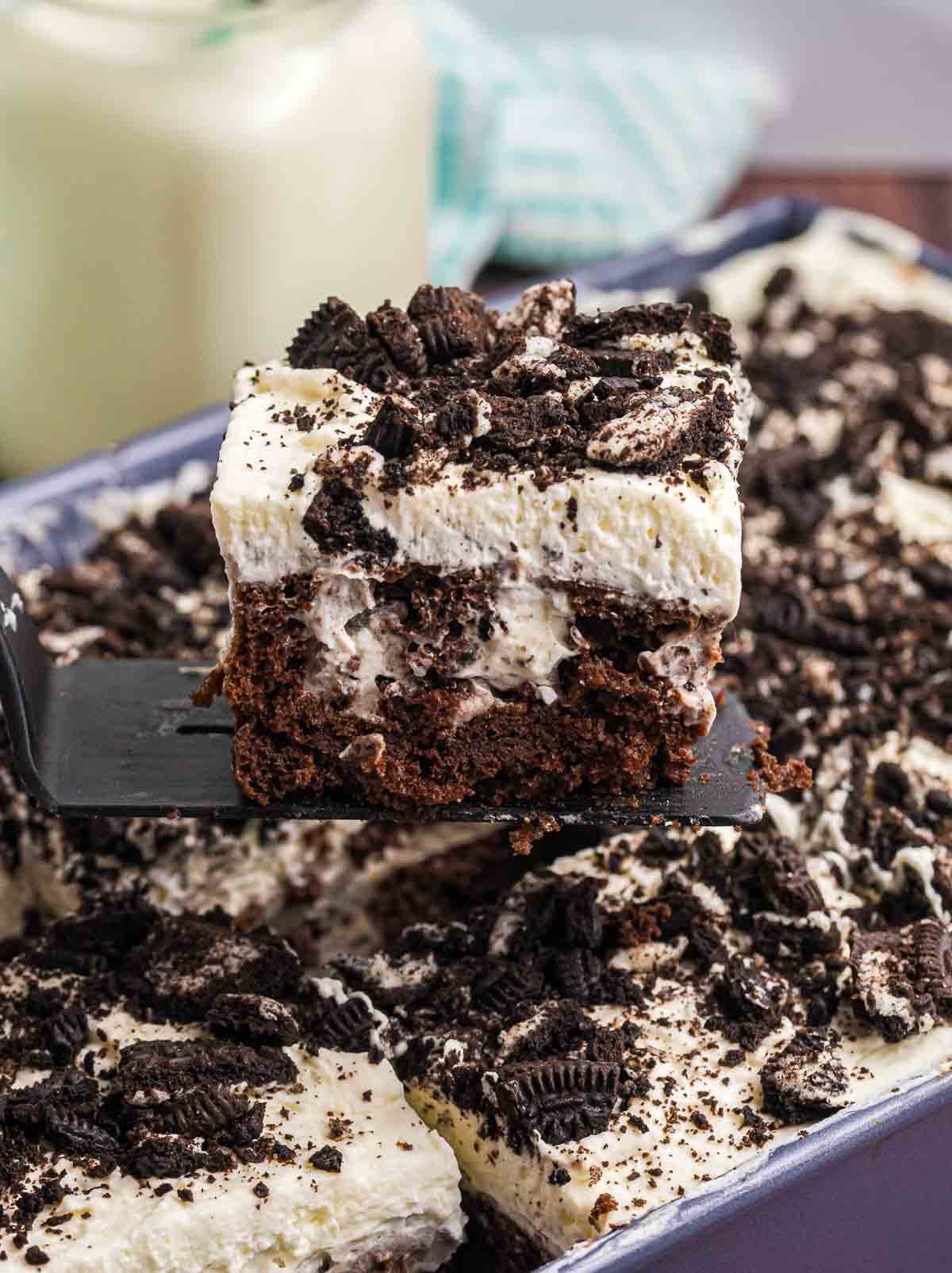 A spatula picking up a piece of cake.