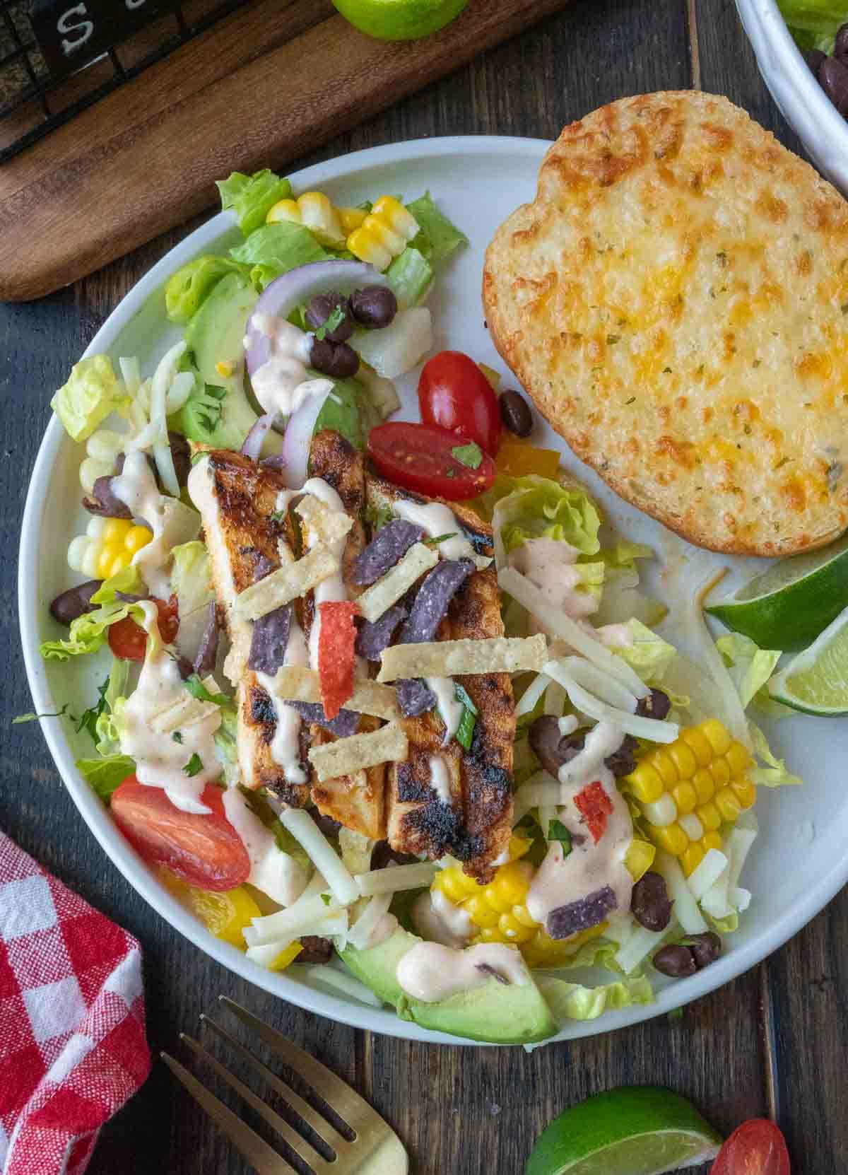 A plate of southwestern chicken salad with a side of texas toast.
