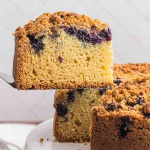 Taking a slice of blueberry crumb cake.