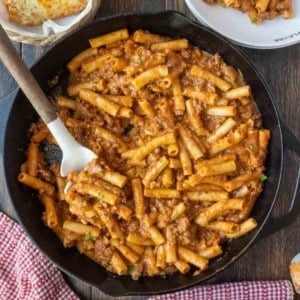 Homemade beefaroni in a skillet with a spatula.