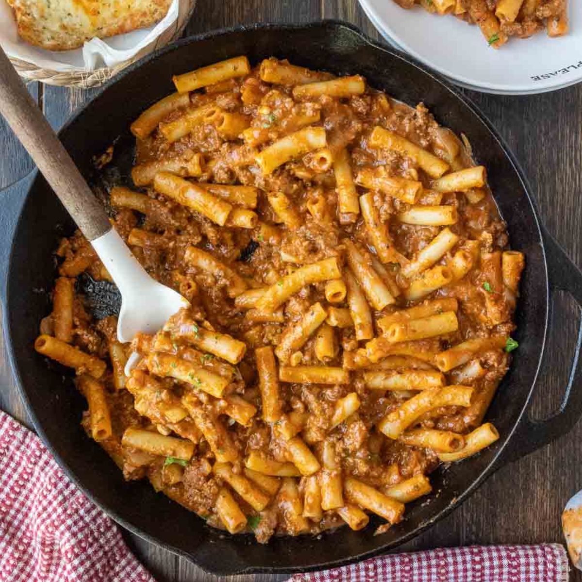 Homemade beefaroni in a skillet with a spatula.