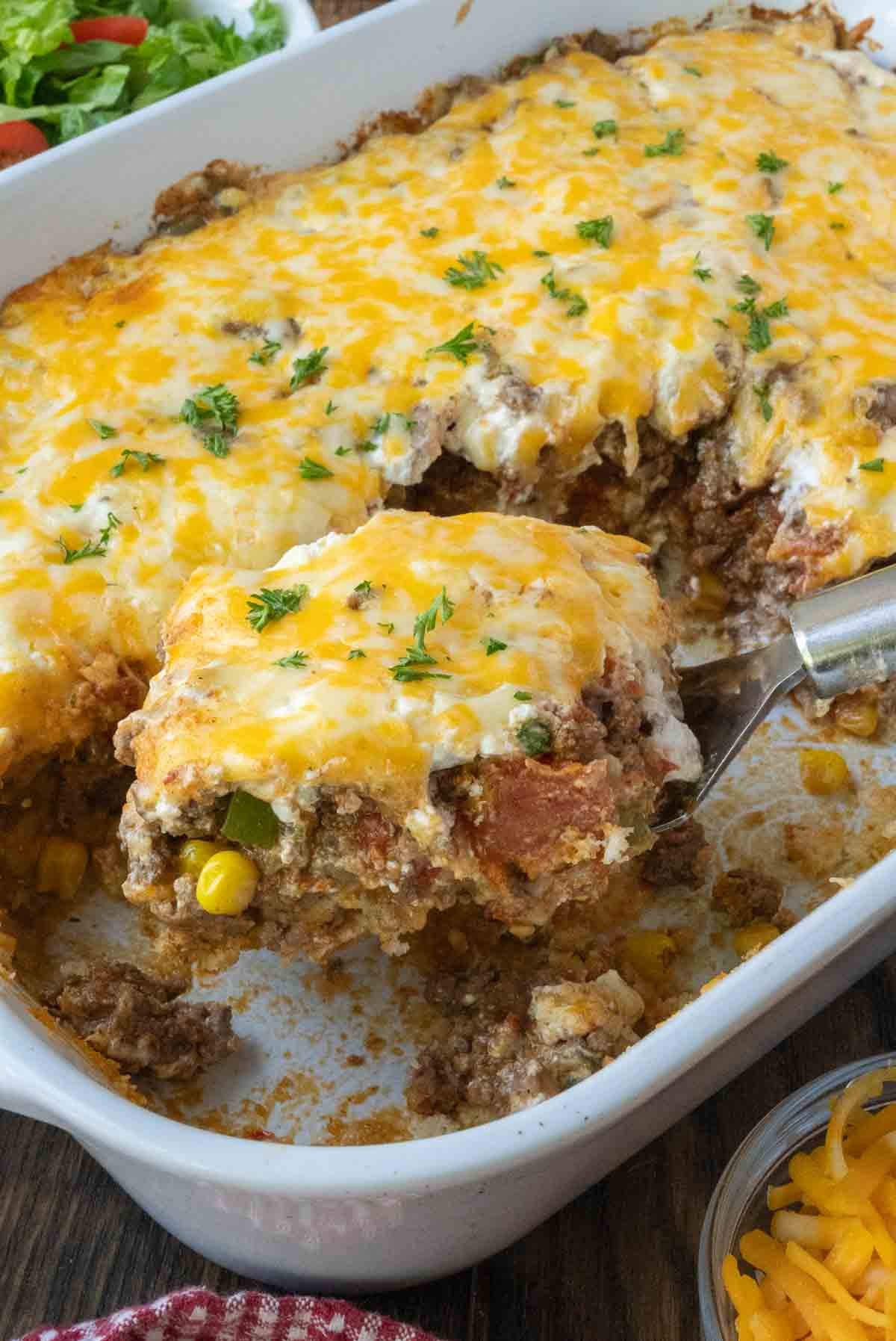 A spatula scooping up some beef casserole.