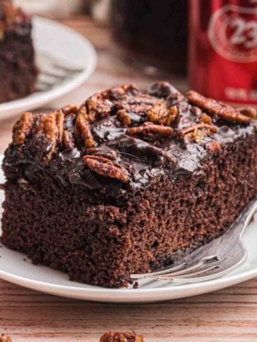 A slice of dr pepper cake on a plate.