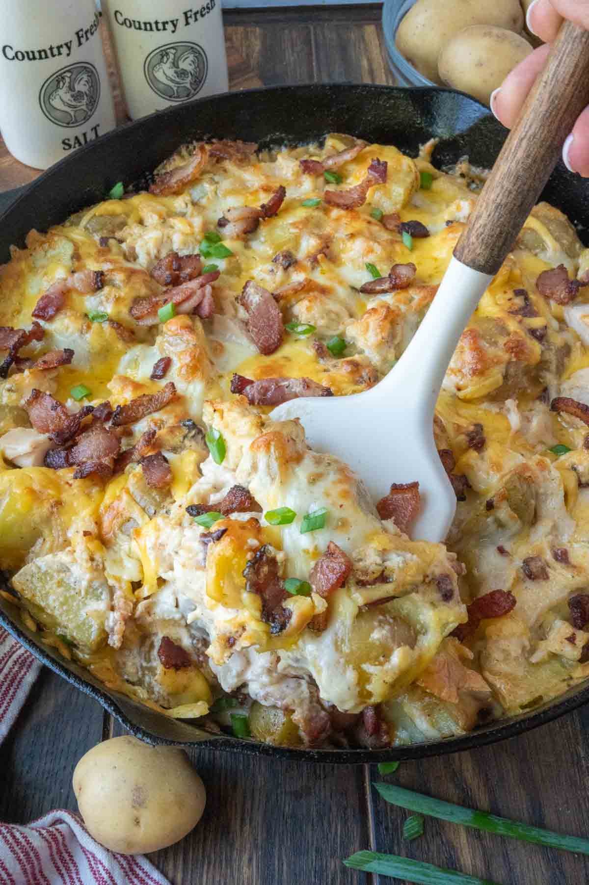A spatula scooping up some potato bake.