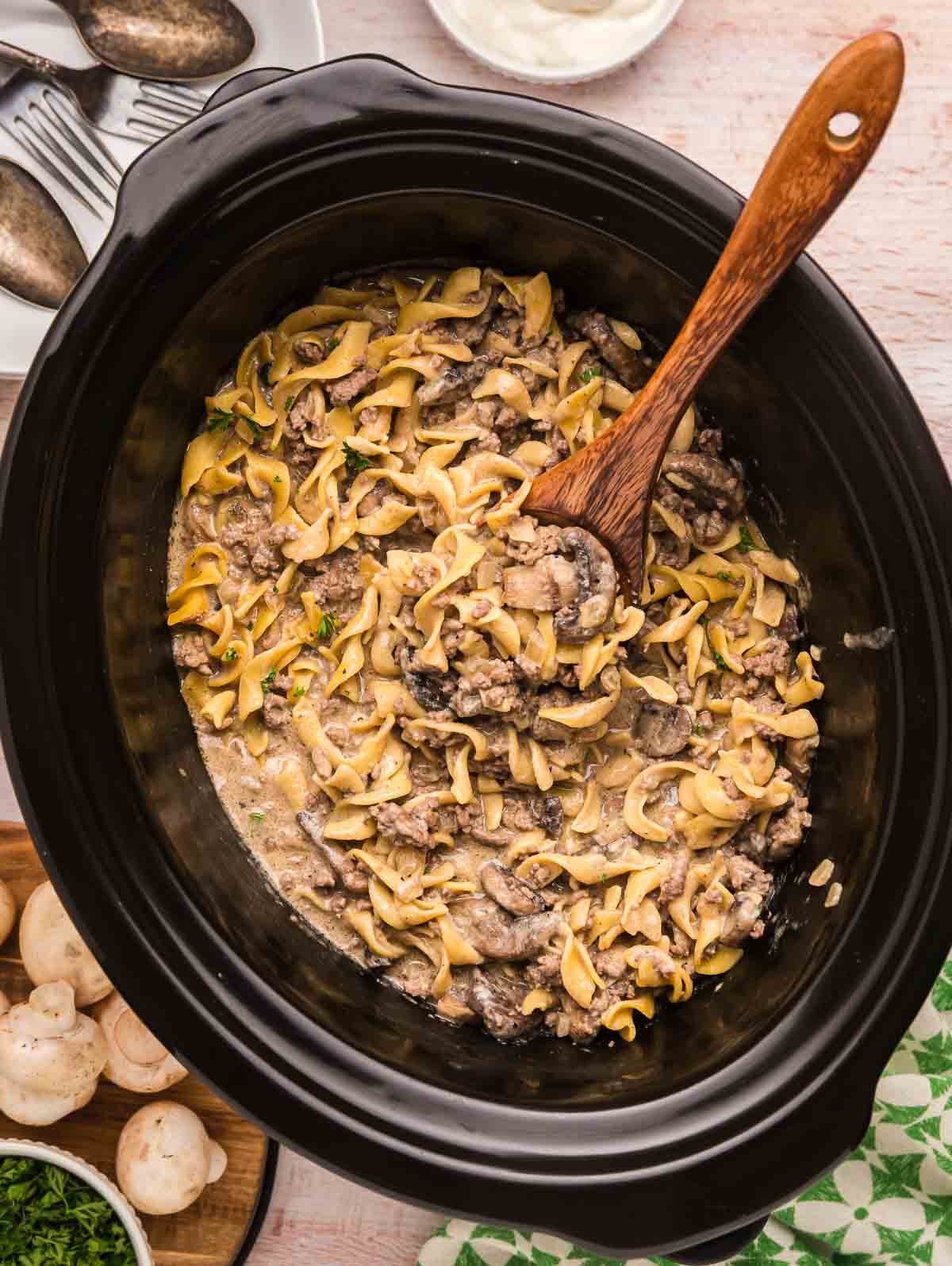 A slow cooker full of ground beef stroganoff.