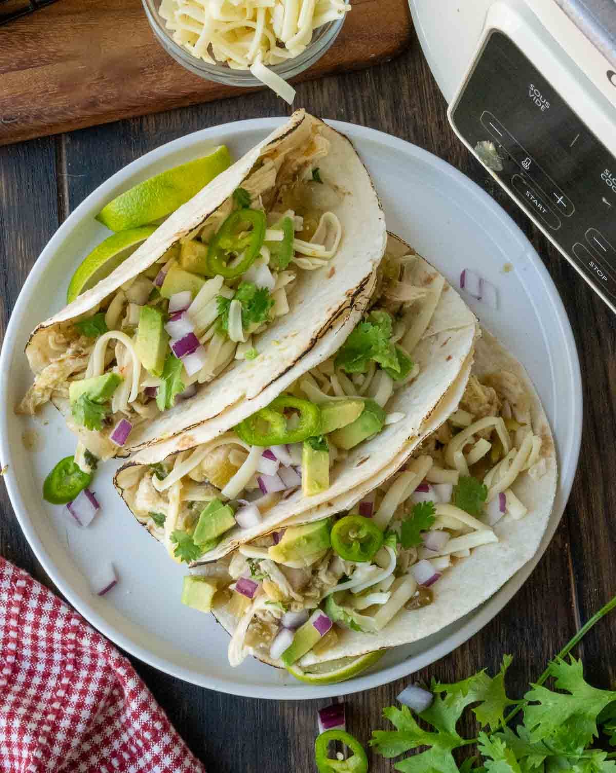Salsa verde chicken served on soft tacos.