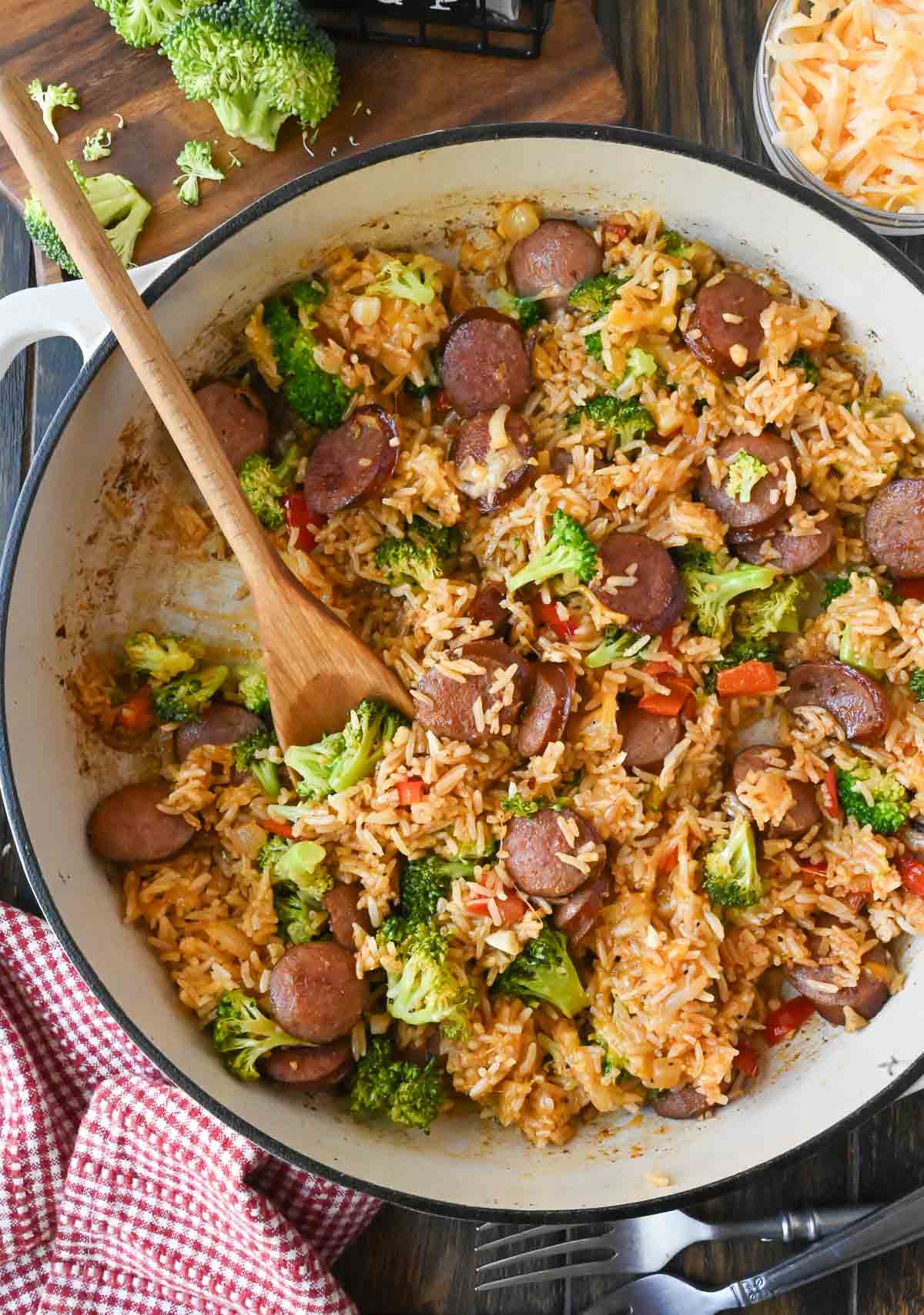 A wooden spoon in the rice skillet.