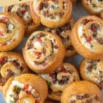 Pinterest graphic featuring golden brown sausage pinwheels.