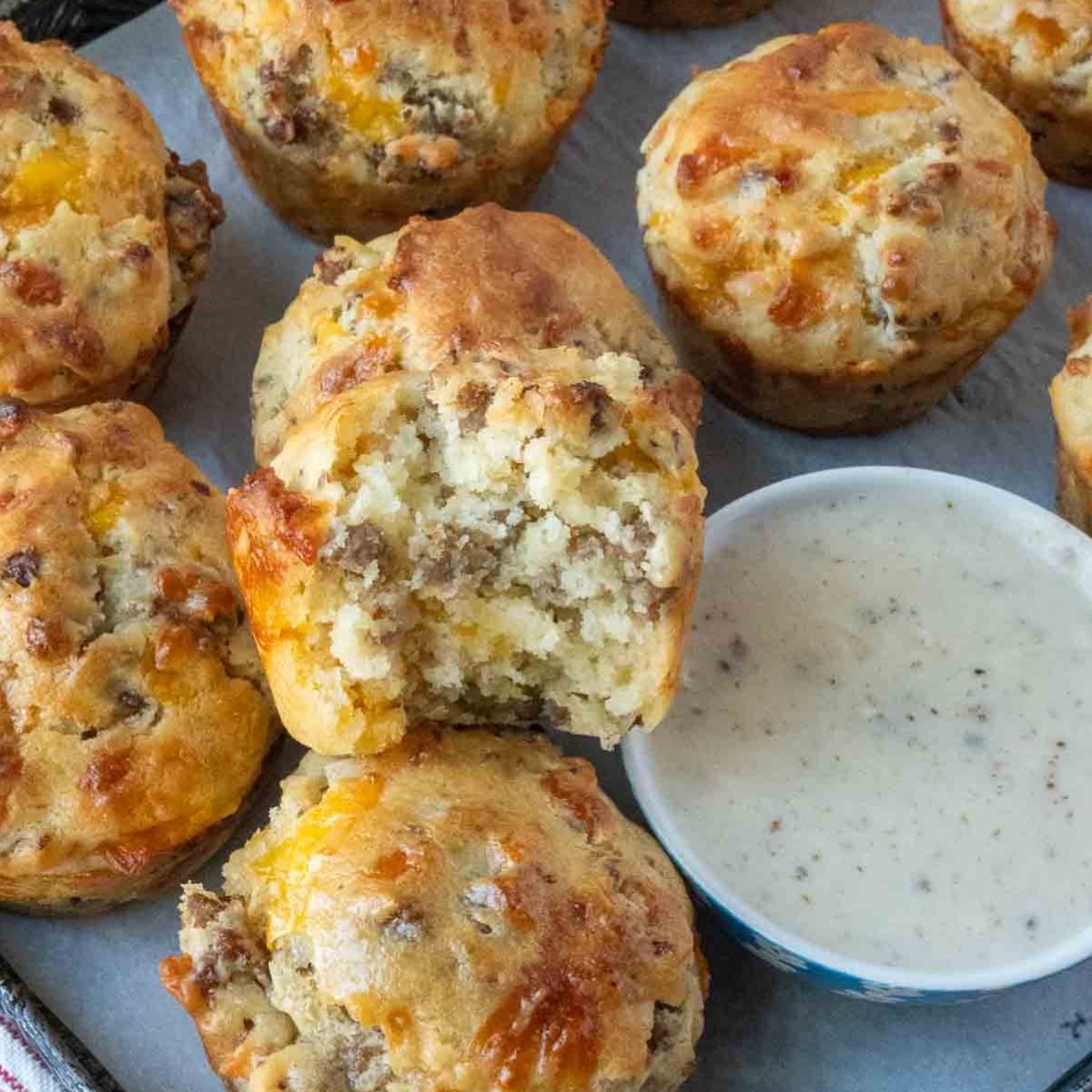 A tray of sausage muffins with gravy.