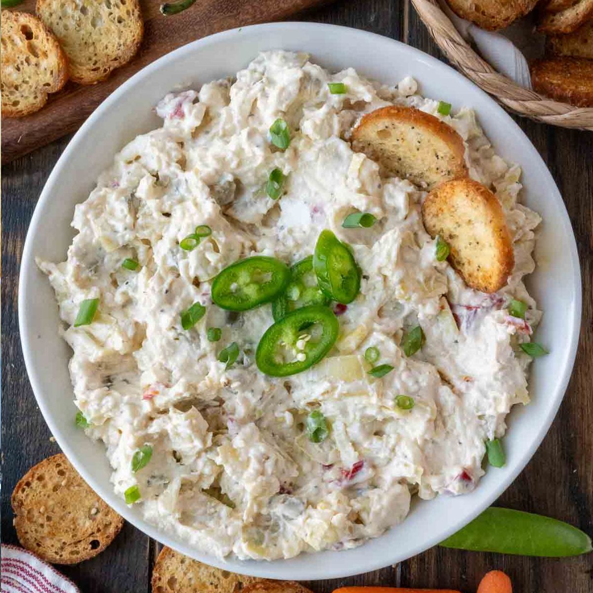 jalapeno artichoke dip in a white bowl.