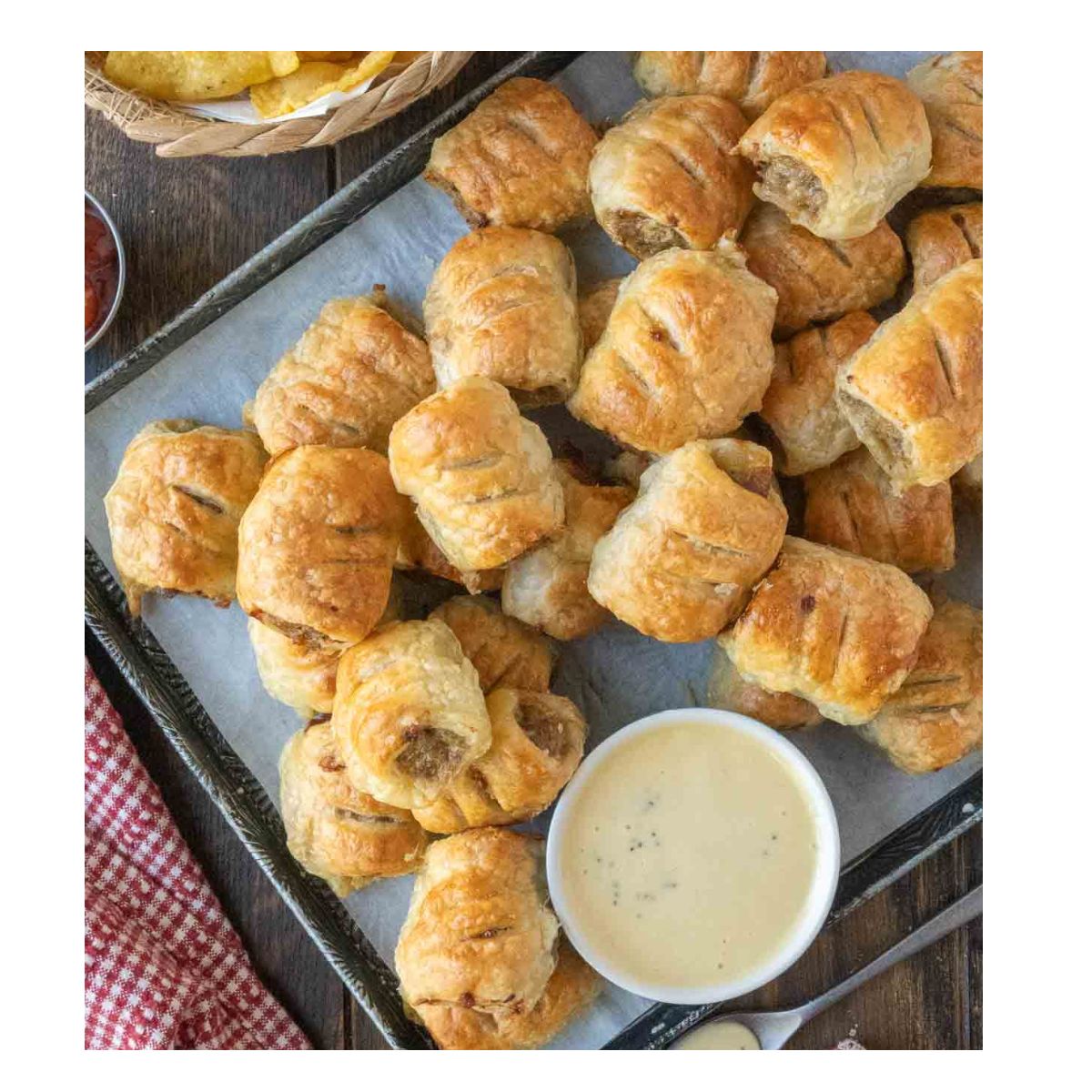 sausage rolls with honey mustard on a platter.