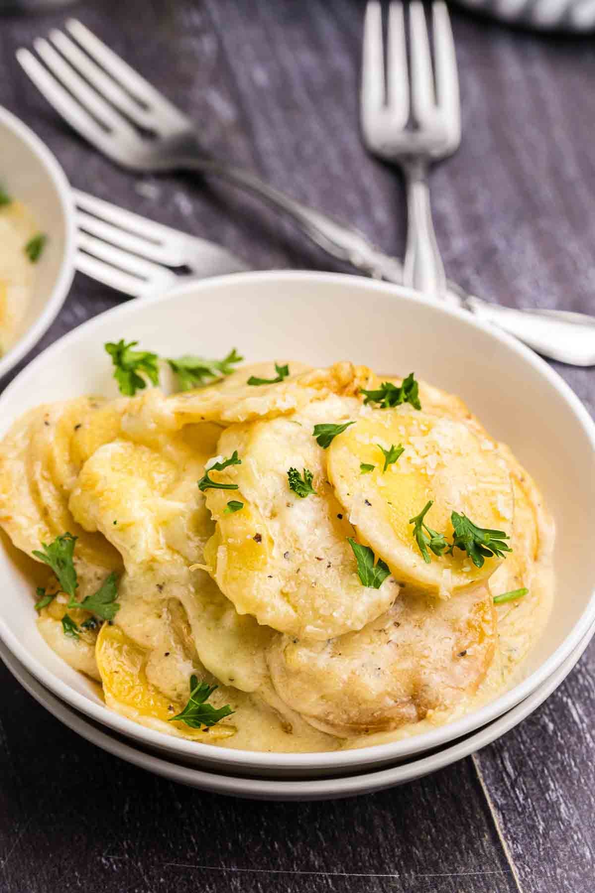 A bowl of crockpot scalloped potatoes.