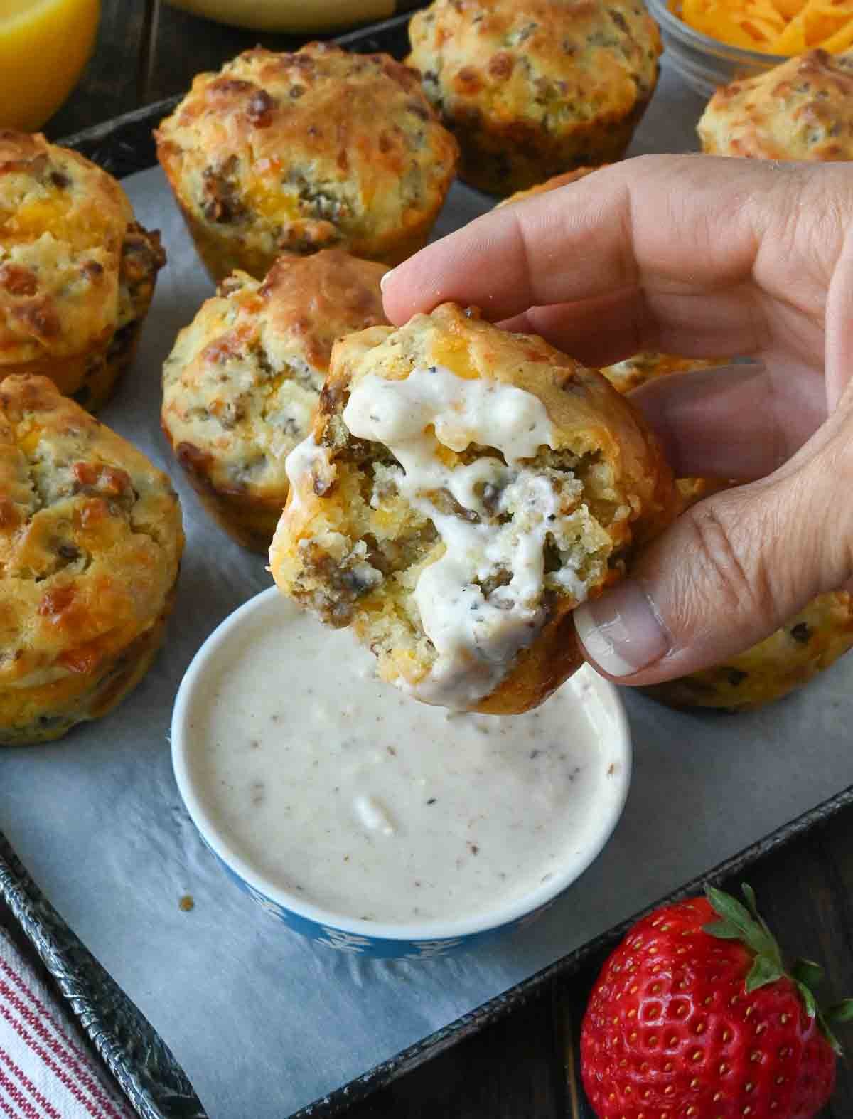 Dipping a sausage muffin in gravy.