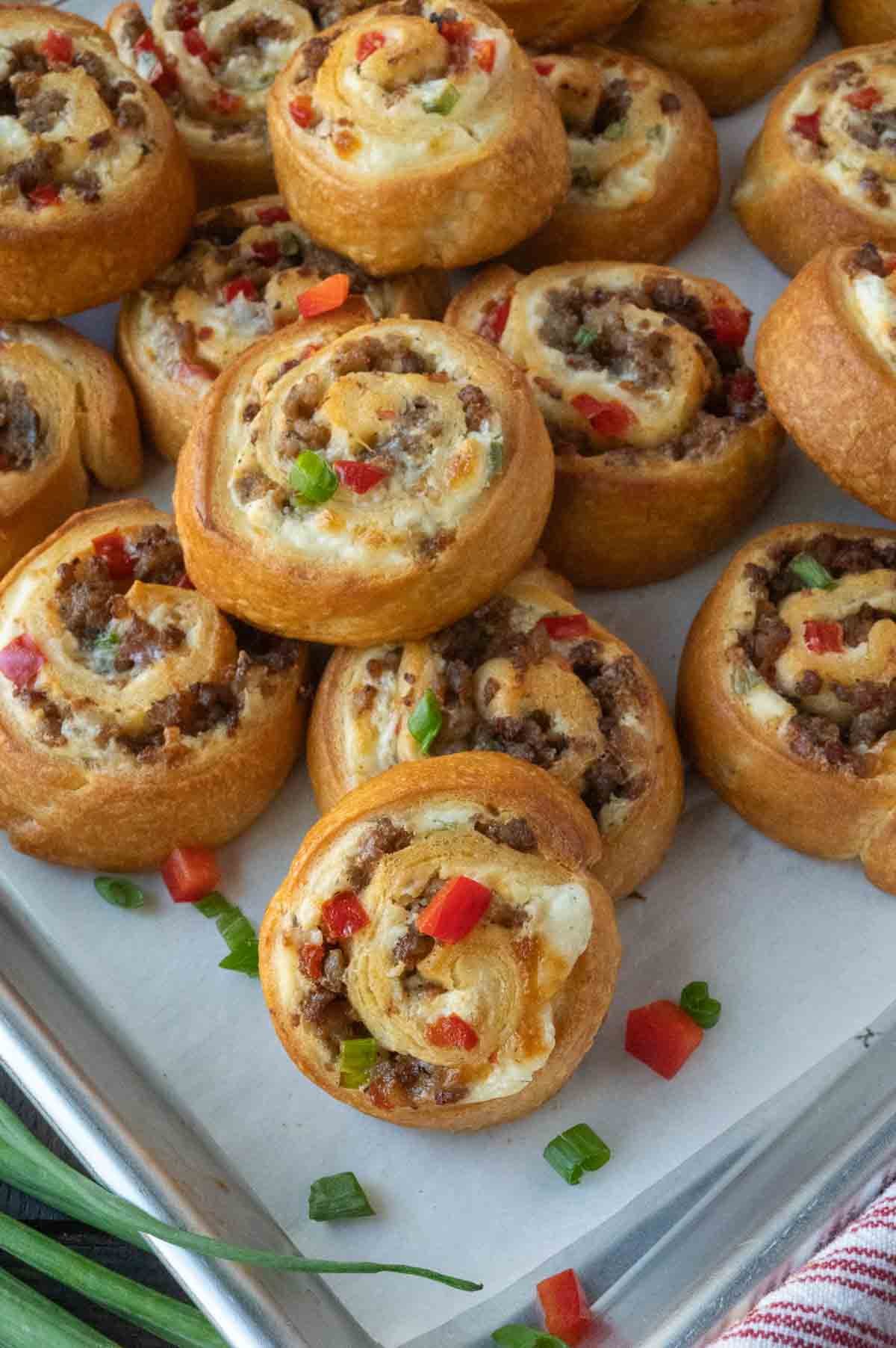 A tray of perfectly baked sausage pinwheels.