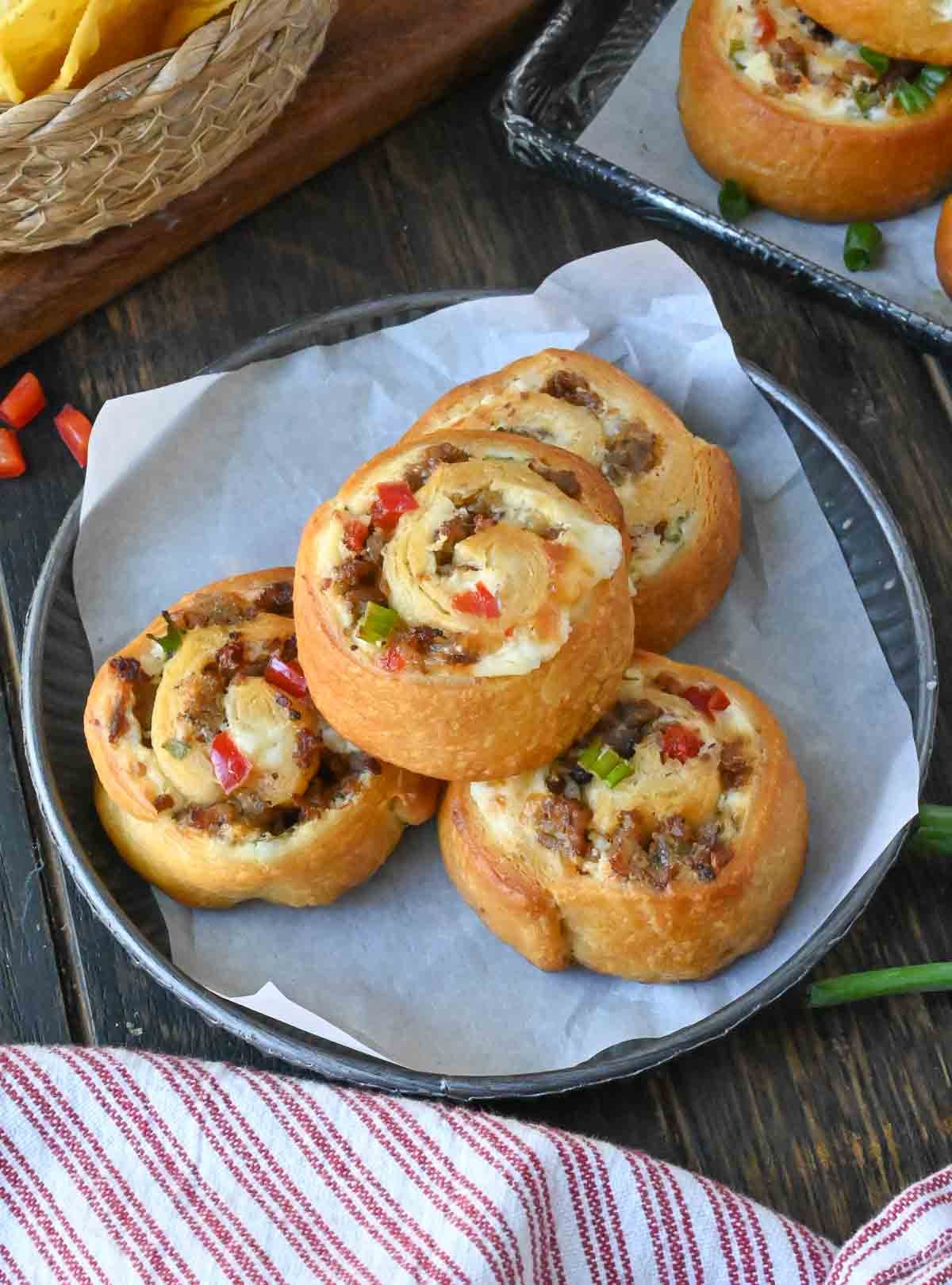 A plate of four sausage pinwheels.