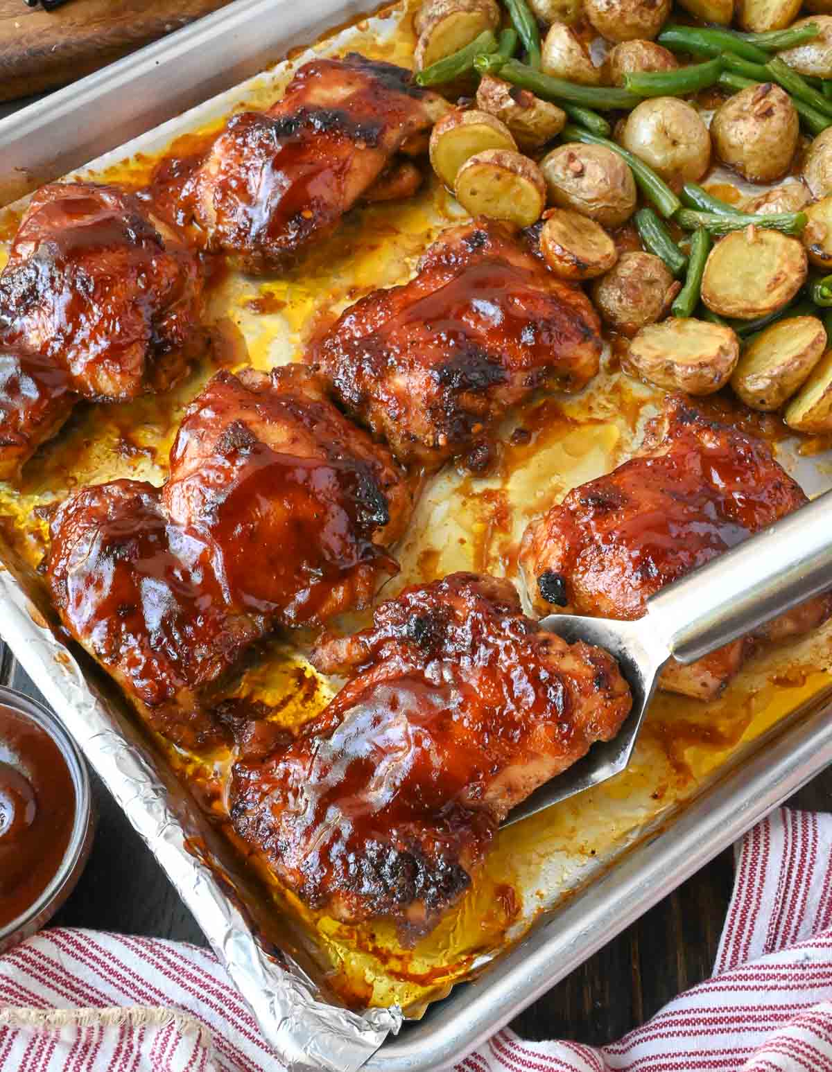 A sheet pan of baked chicken potatoes and green beans.