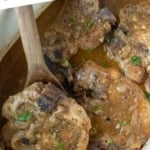 Slow cooker smothered pork chops in a slow cooker pinterest pin.