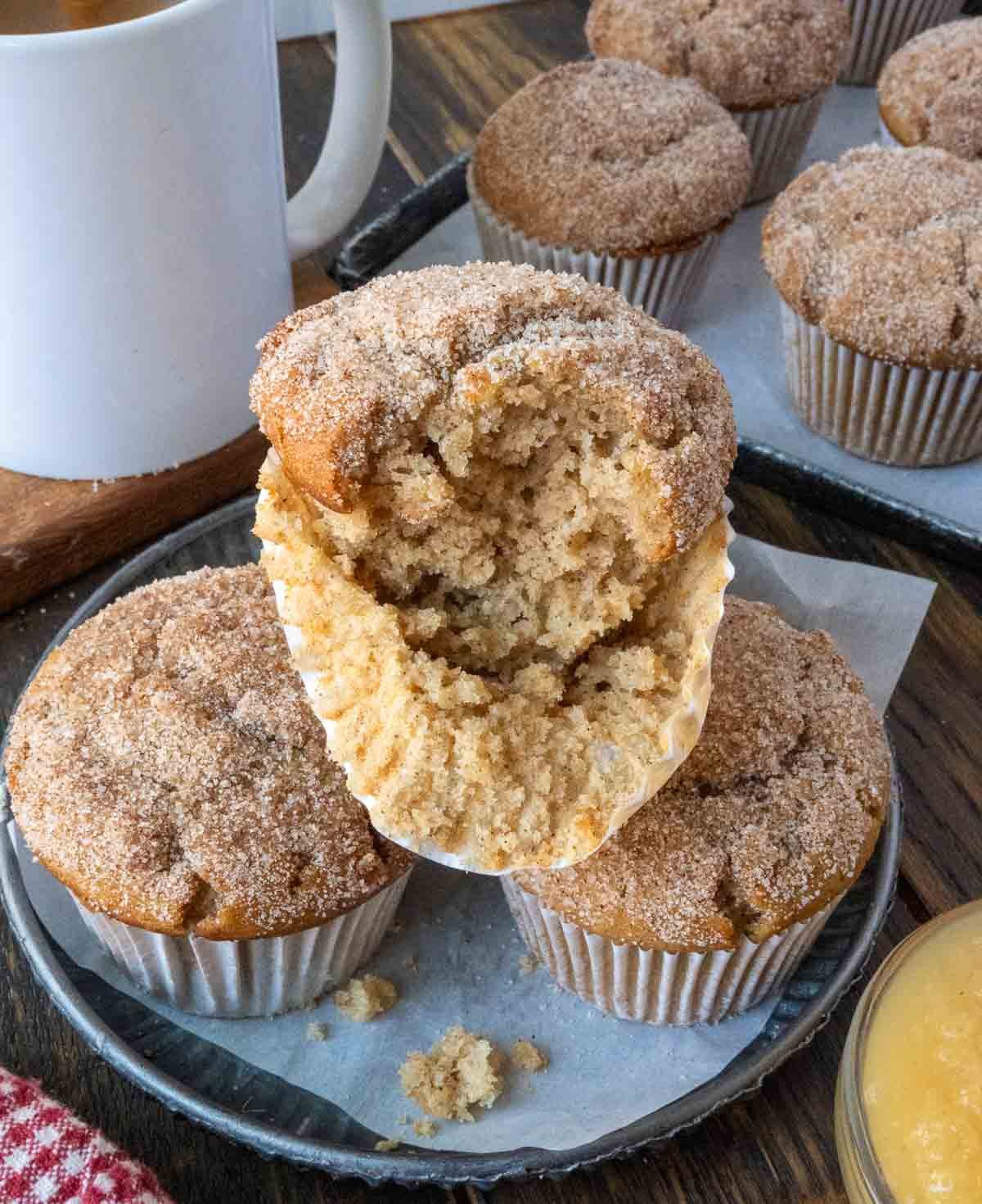 Three apple cider muffins on a plate.