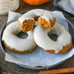 Three donuts on a plate.