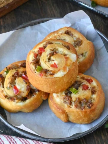 Three sausage pinwheels on a plate.
