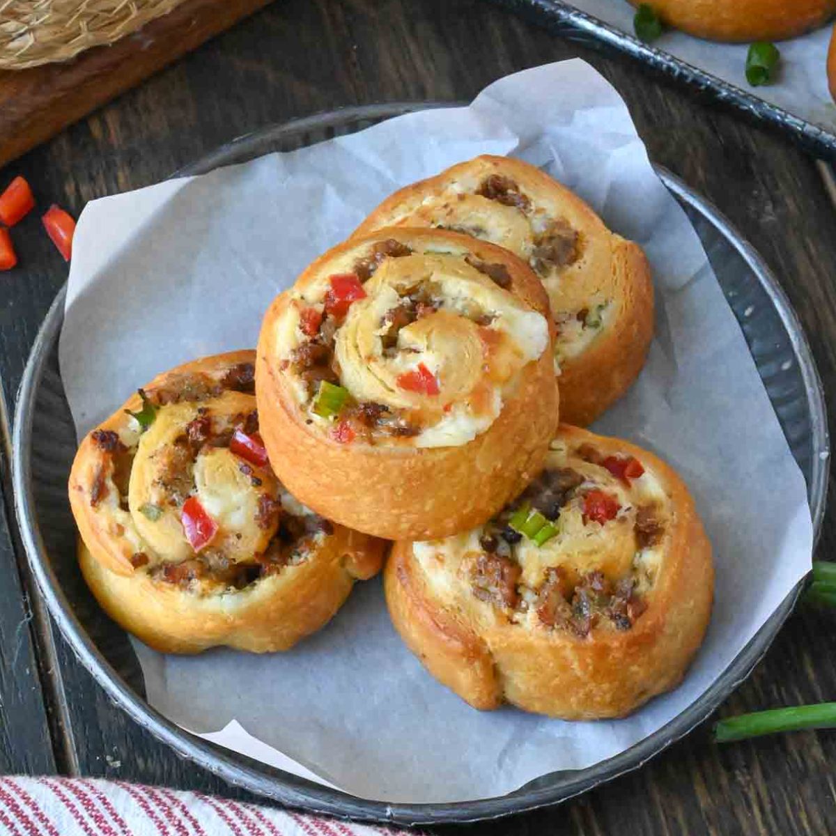 Three sausage pinwheels on a plate.