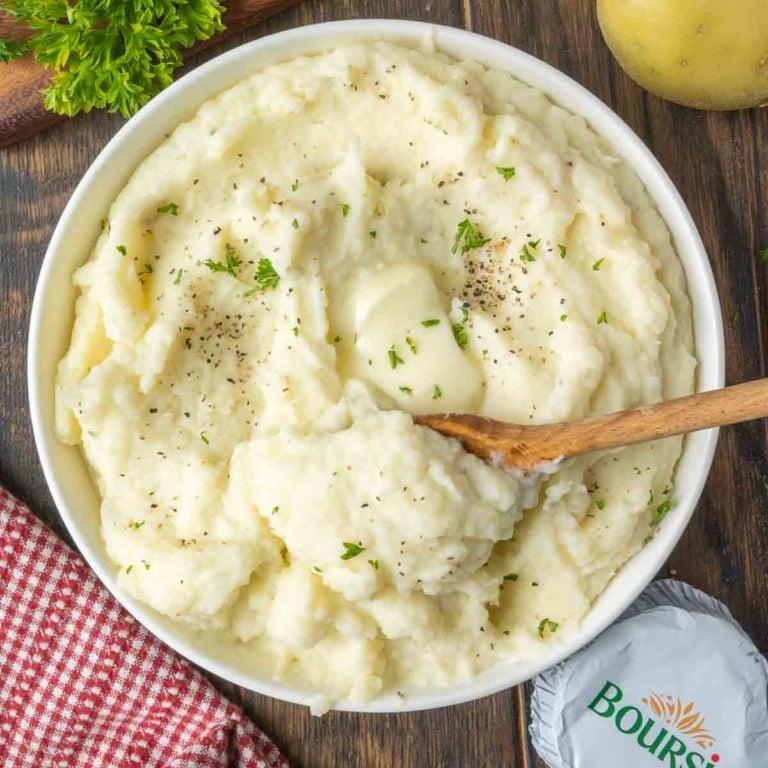 A bowl of mashed potatoes with boursin cheese.