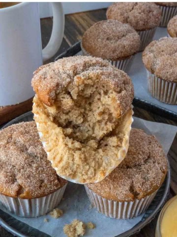 Apple cider muffins on a plate.