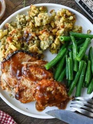A plate with crockpot turkey breast, green beans, and stuffing
