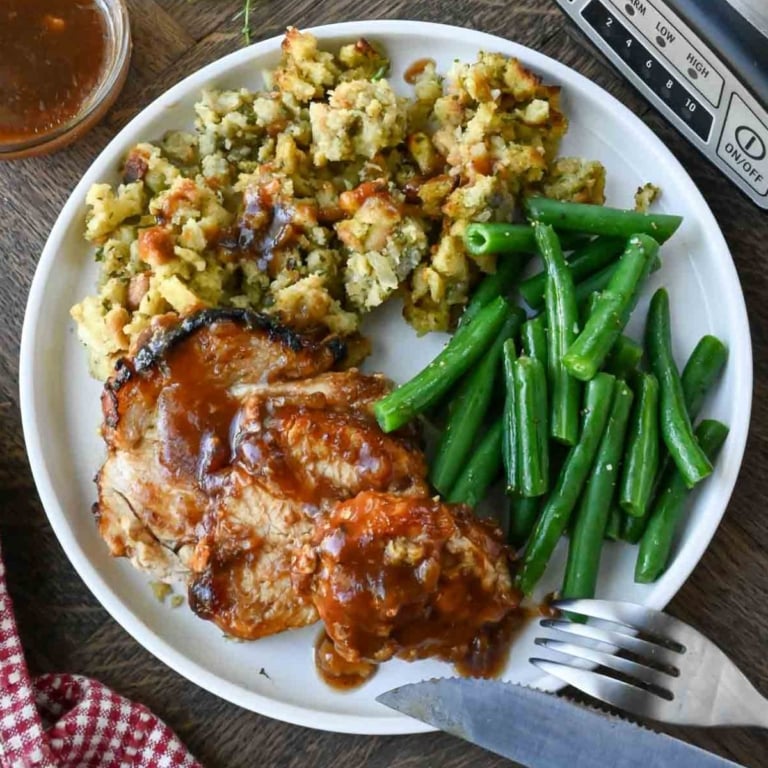 A plate with crockpot turkey breast, green beans, and stuffing