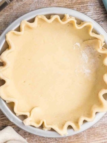 Homemade pie crust pressed into a pie tin.