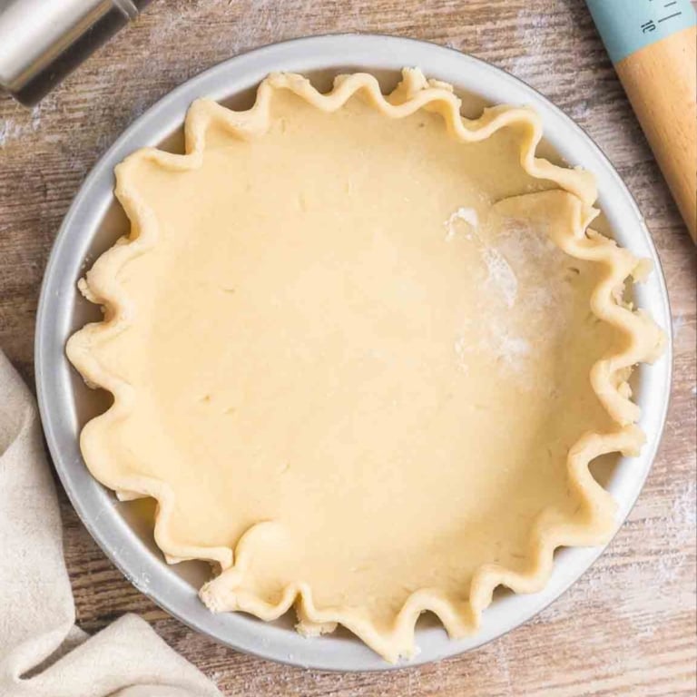 Homemade pie crust pressed into a pie tin.
