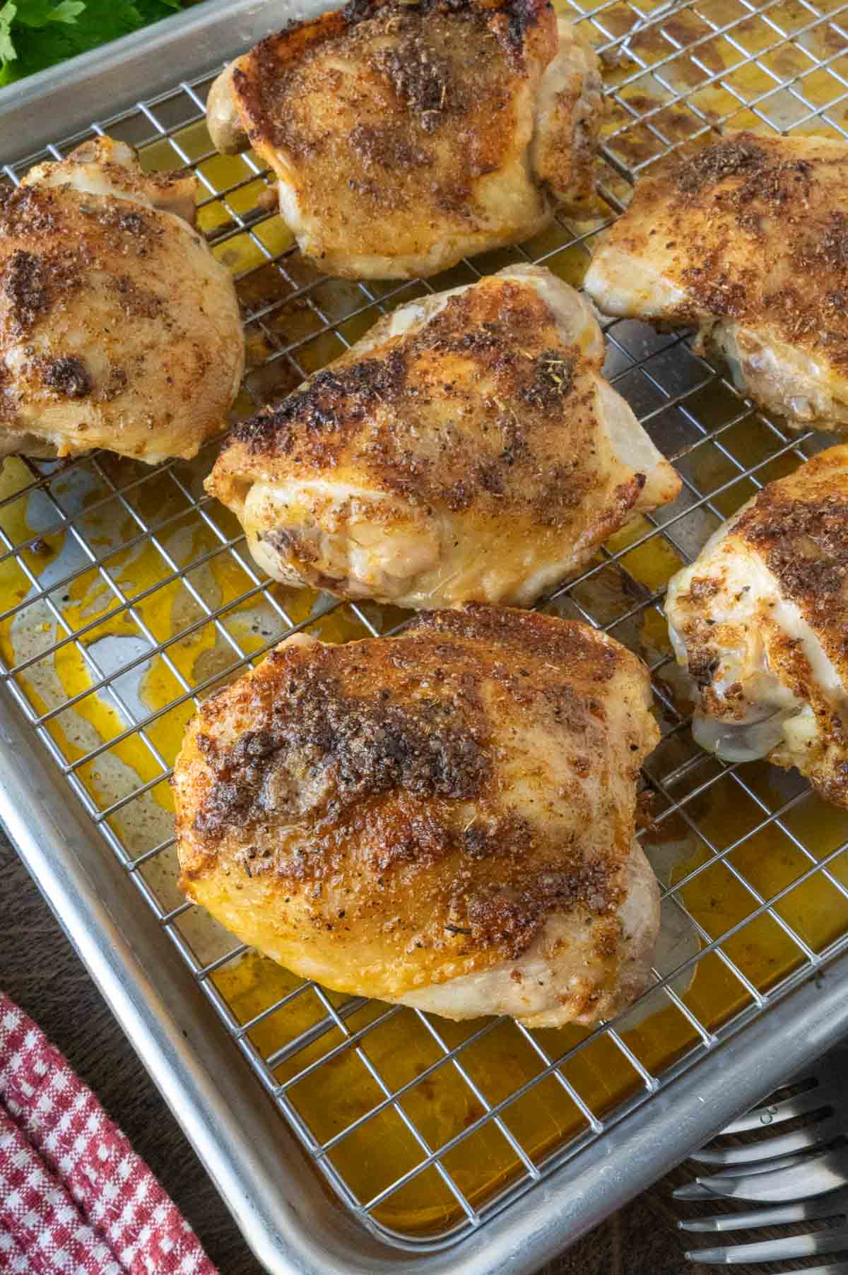 A tray of crispy roasted chicken thighs.