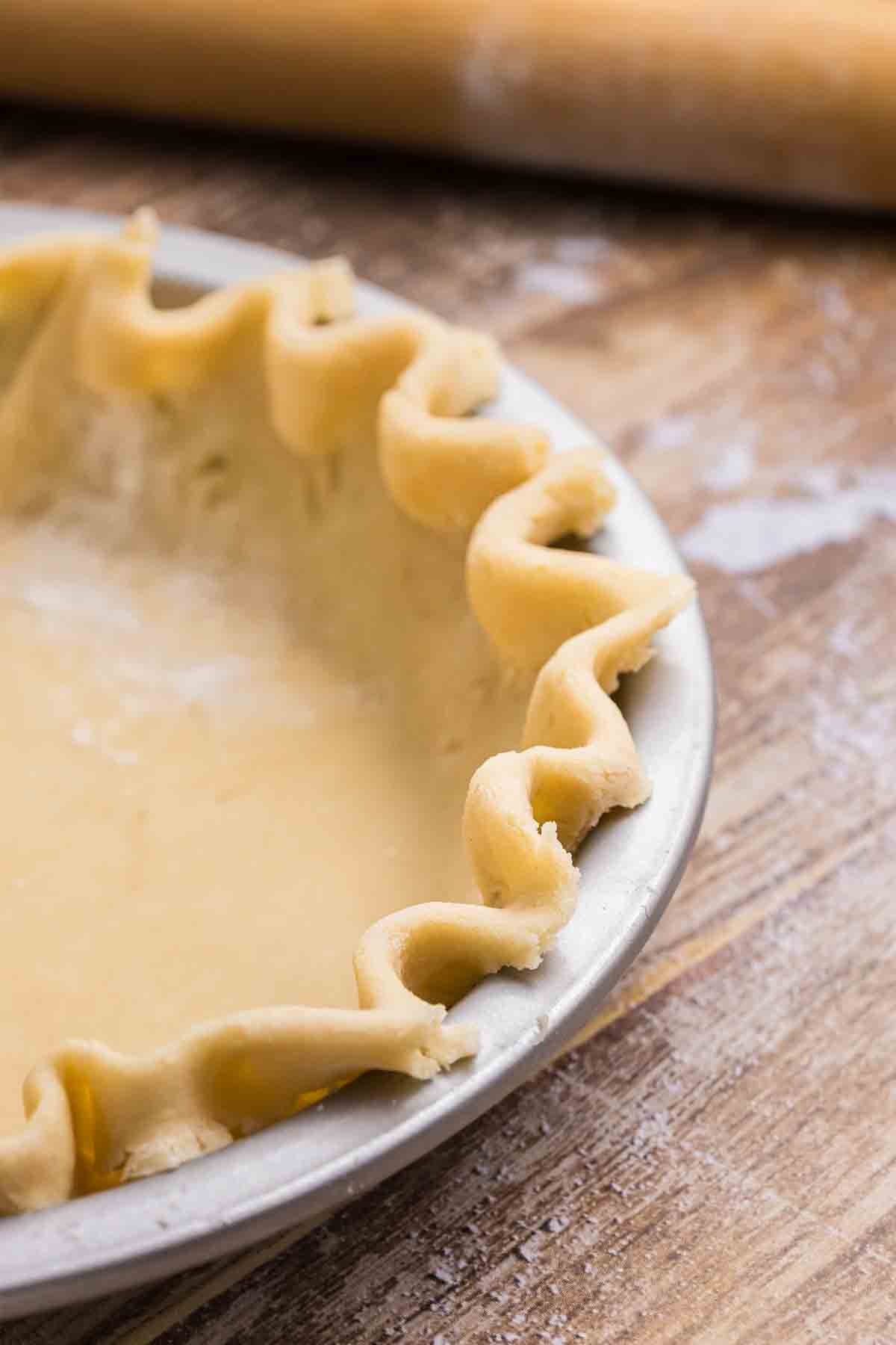 Homemade pie crust pressed into a pie tin.