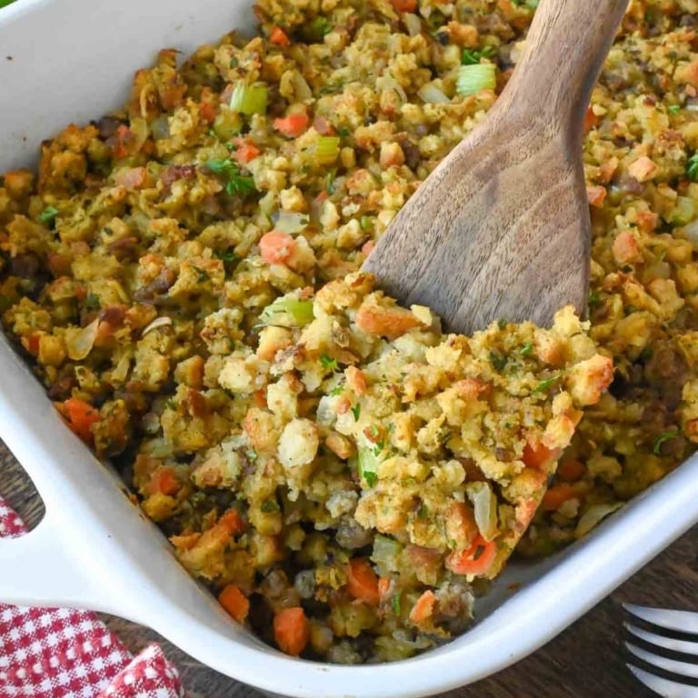 Close up of a wooden spoon taking a scoop of semi homemade box stuffing.