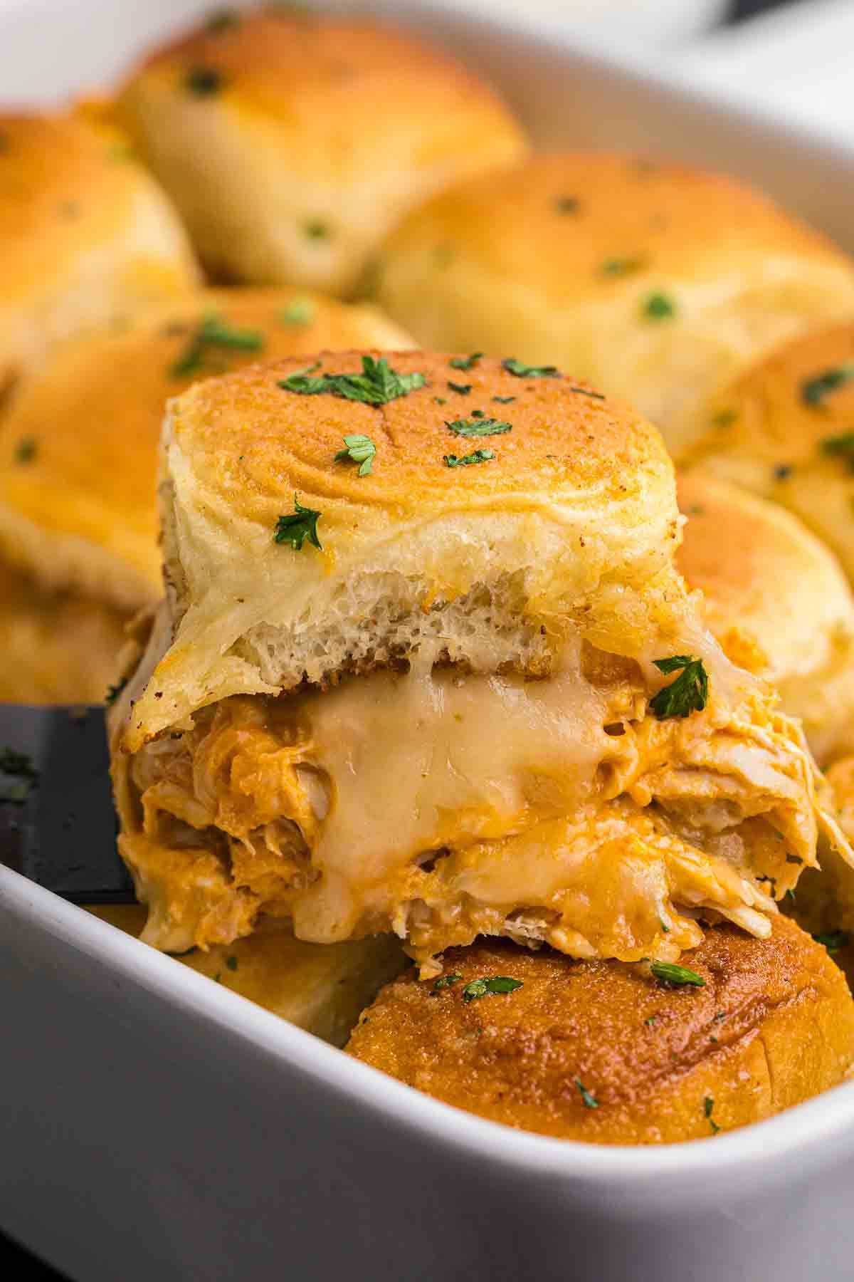 A baking dish full of buffalo chicken sliders.