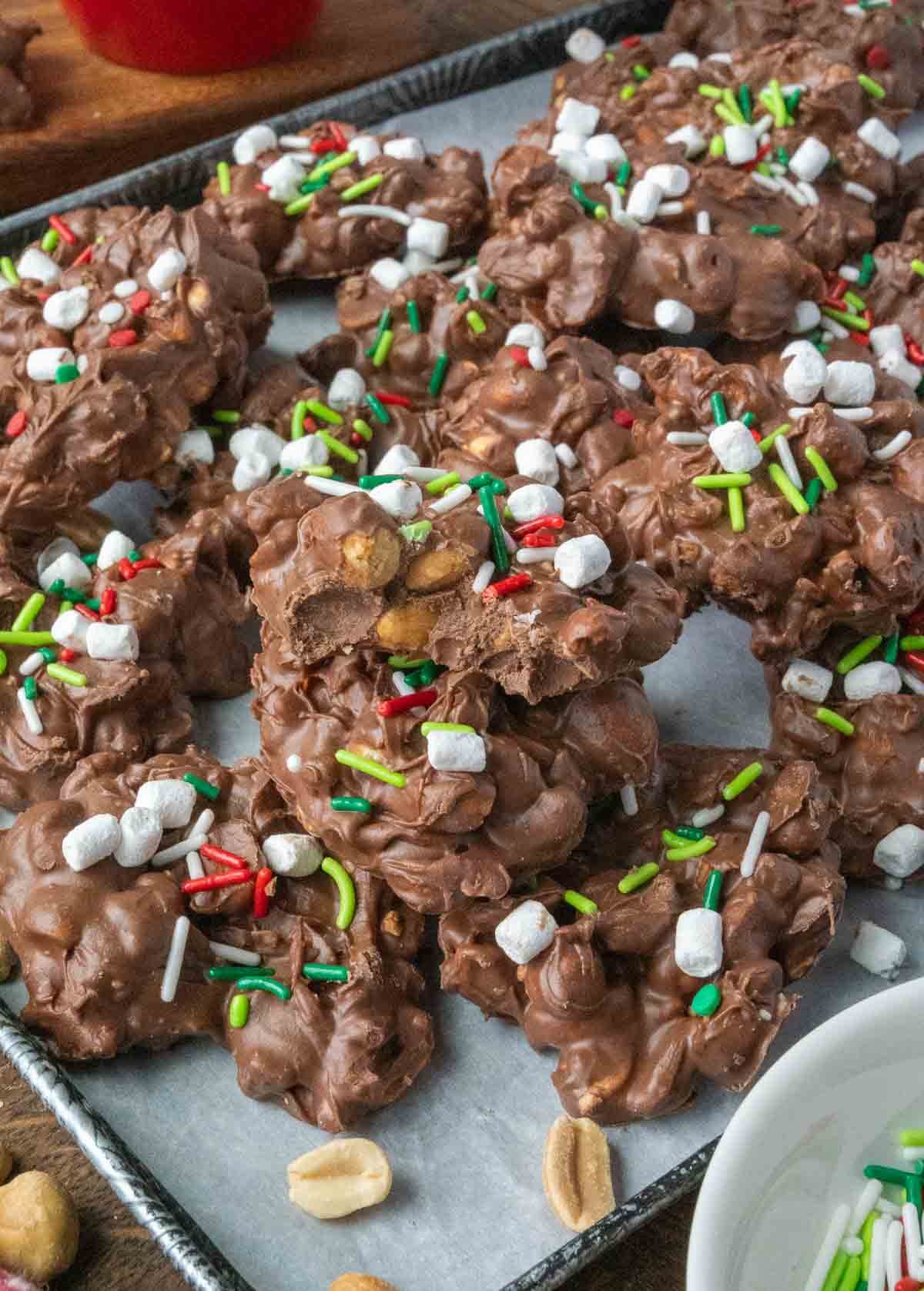 A parchment lined baking sheet covered in crockpot christmas candy.