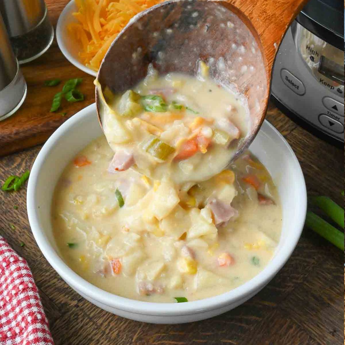 A ladle pouring soup into a bowl.