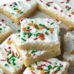 A pile of frosted sugar cookie bars.