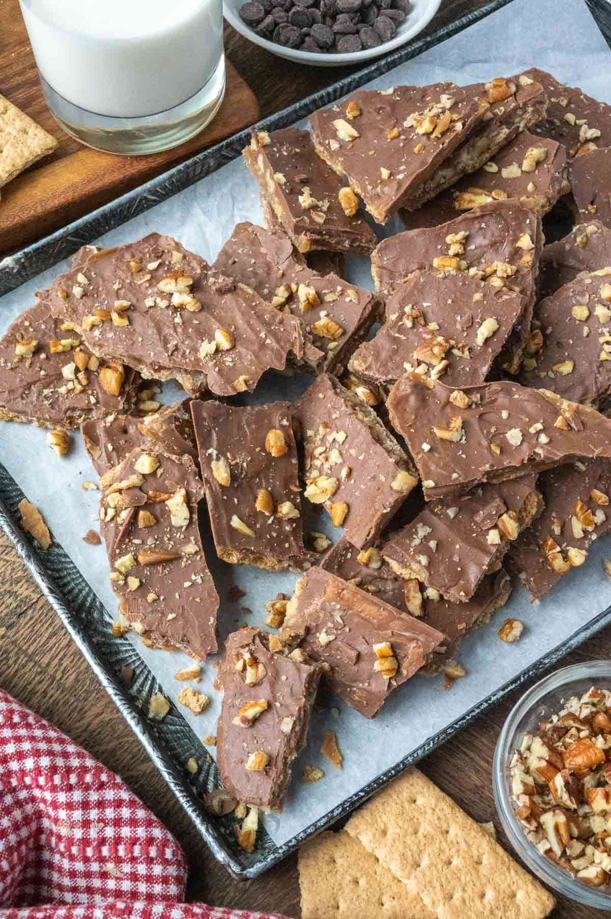 Pieces of broken toffee on a baking sheet.