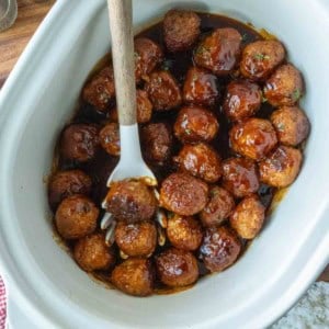 Cooked fire cracker chicken meatballs with a serving spoon.