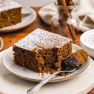 A plate with a fork and slice of gingerbread cake.