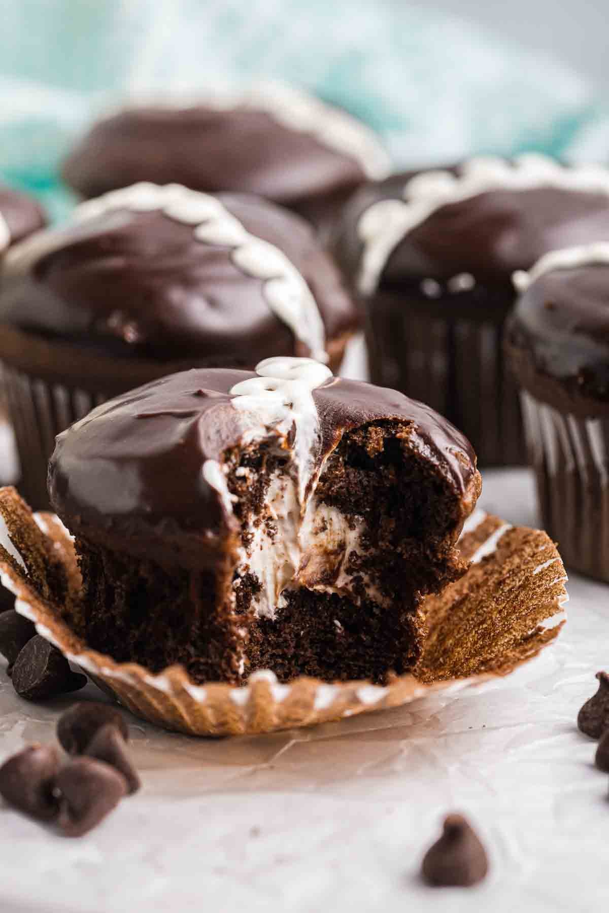 Hostess chocolate cupcakes, one with a bite taken out of it.