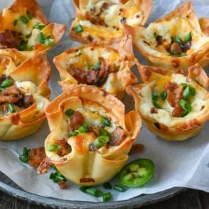 Jalapeno popper wonton cups on a plate.