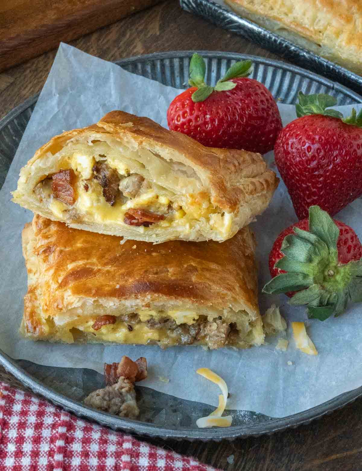 A plate of breakfast hot pockets served with strawberries.