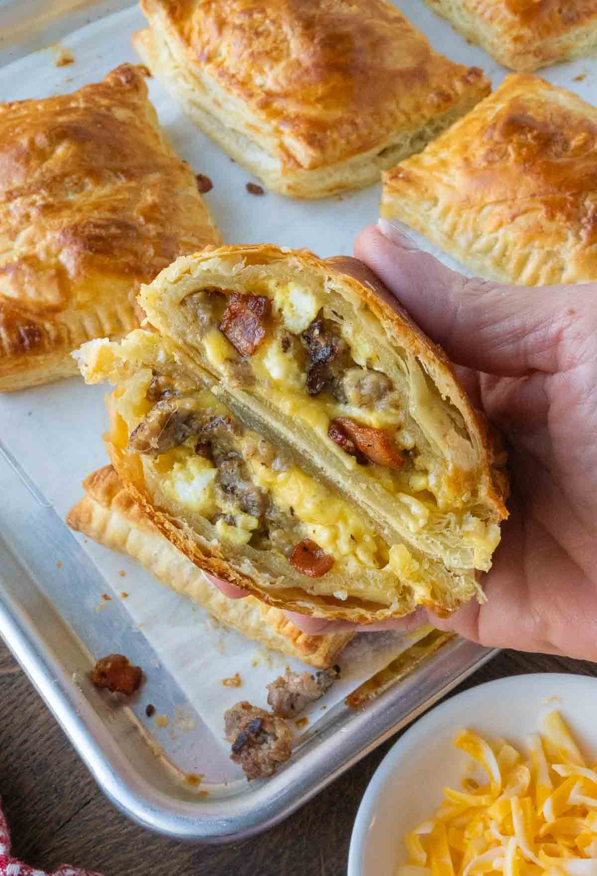 Holding up two halves of a breakfast hot pocket.