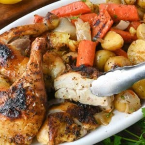 Close up of dutch oven roasted whole chicken with vegetables.