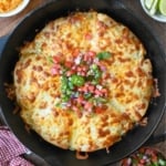 Top down view of cheesy beef pockets in a skillet.