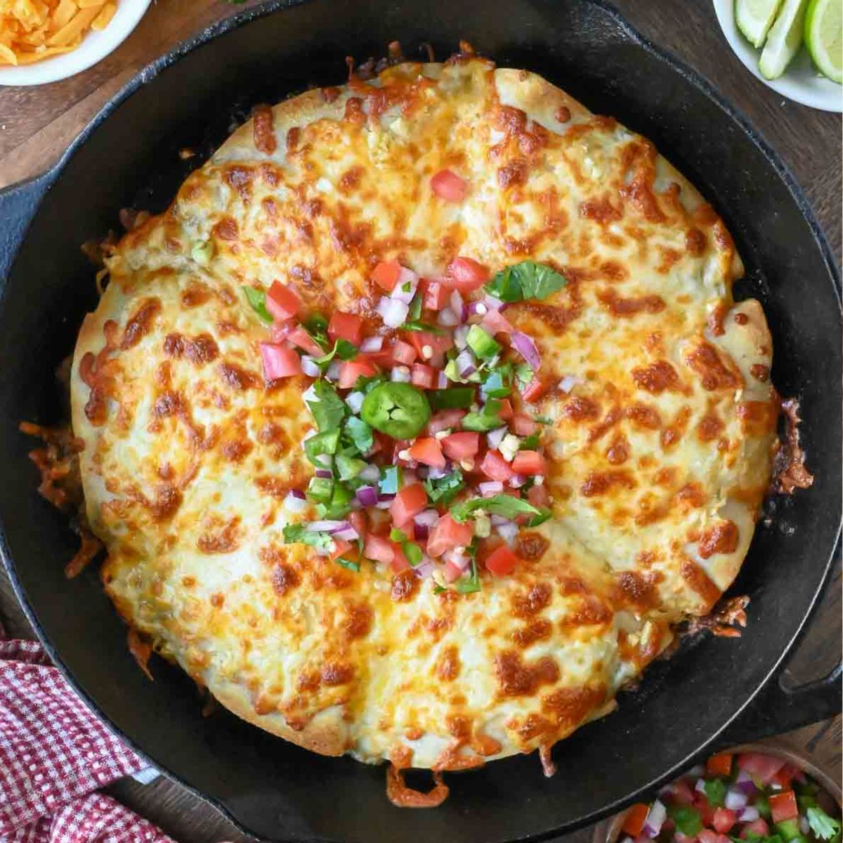 Top down view of cheesy beef pockets in a skillet.
