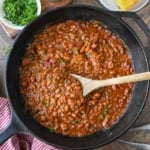 Overhead view of cowboy baked beans recipe in a cast iron skillet.