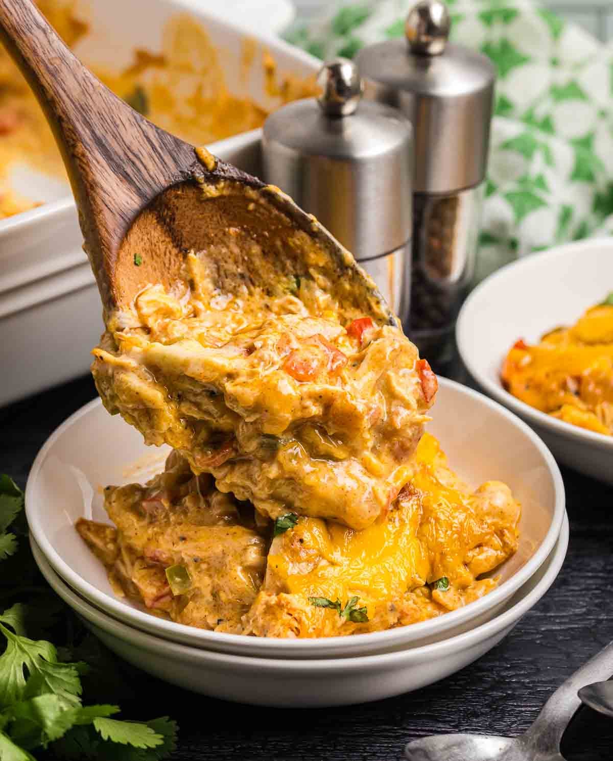 Spooning ranch chicken salad into a bowl.